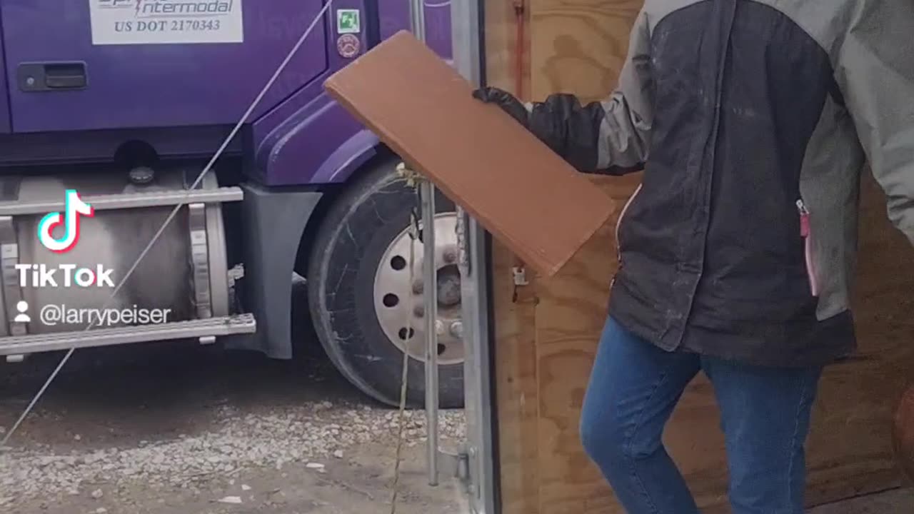 Jessica helping empty trailer into our garbage container. Suburban Junk Removal