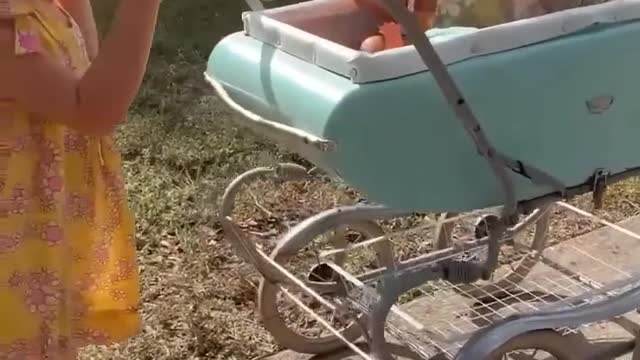 Little Girl Wears Goggles And Push Toddler On a Cart