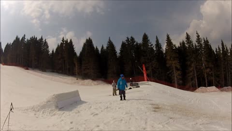 Snowboarder wipes out after hitting jump