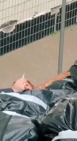 COVID-19 Crisis Actor "Body Bag" SMOKING a CIGARETTE