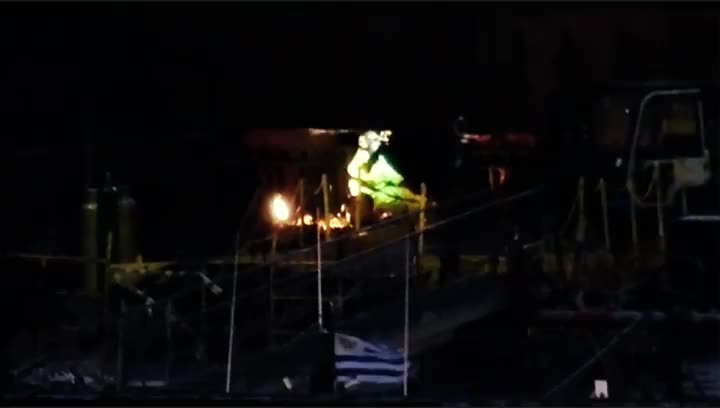 Hard work: welding a ship in a shipyard at night, Puerto de Montevideo