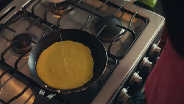 Woman serving eggs in a pan for breakfast