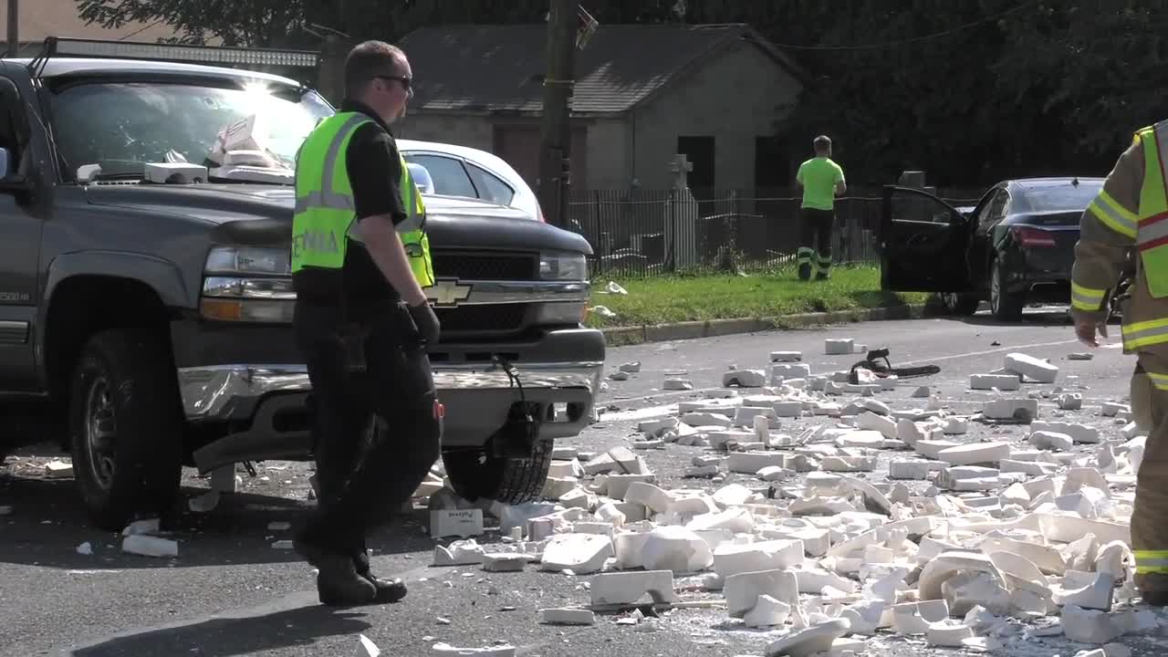 4 car crash litters roadway with concrete blocks