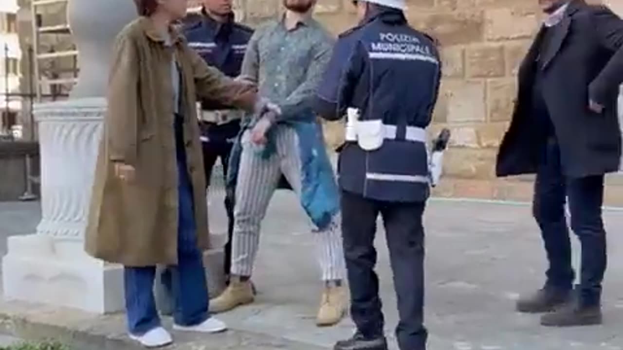 Mayor of Florence Dario Nardella stops an "environmental activist" who daubed paint on the facade...