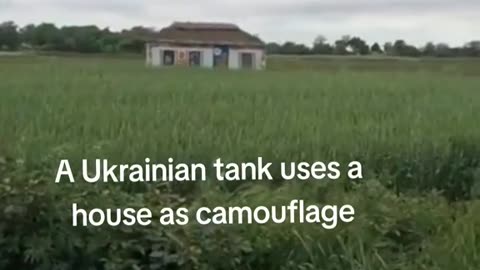 Ukrainian tank uses house as camouflage