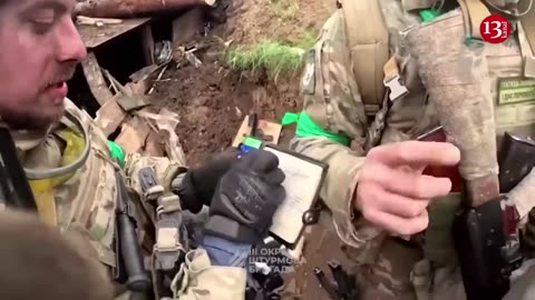 Ukrainian fighters display the killed Russians and the captured weapons near Bakhmut