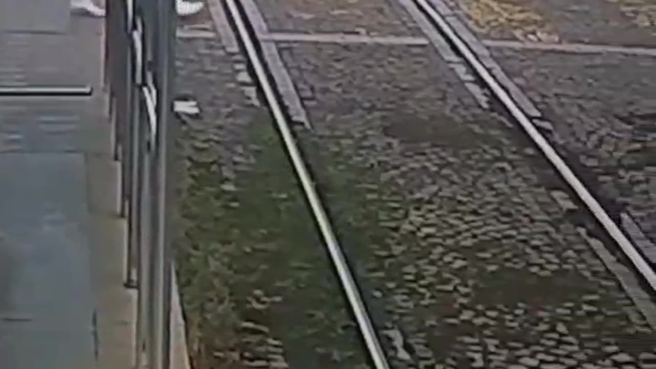 holy shit that was close- chick almost gets ran over by train.