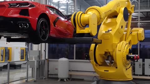 FANUC robot tossing a Corvette around