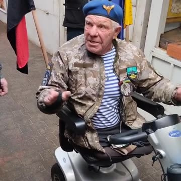 Ukraine in 30 seconds: a crippled man in a mobility scooter with a WWII Nazi collaborator