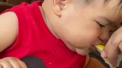Baby funny reaction on lemon