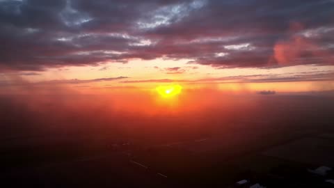 Drone flies through mist to film dramatic sunset