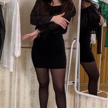 trying on a black polka dot shirt