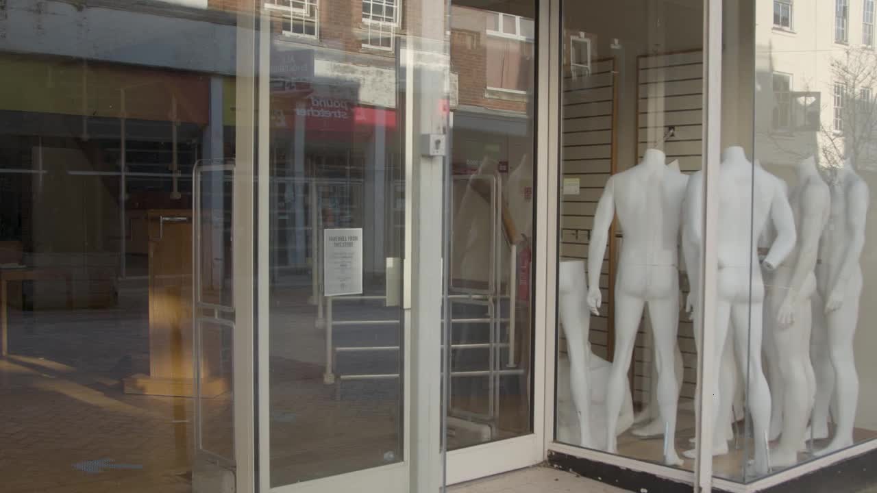 Medium Shot of Mannequins In Closed Down Shop Window