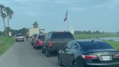 This is a Line of Family Members and Sponsors waiting to pick up illegal migrants at Texas Border