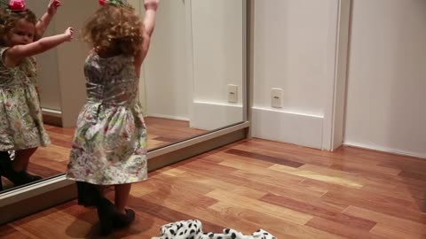 Little Girl Dances in Front of Mirror