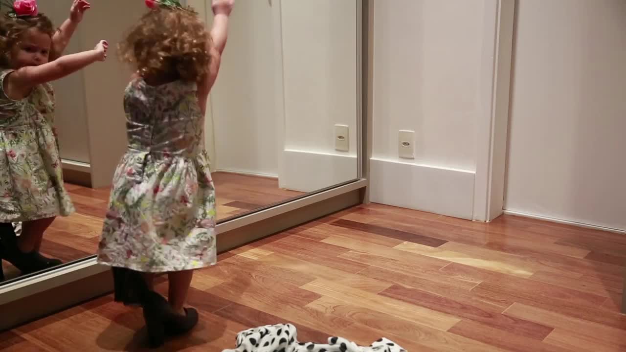 Little Girl Dances in Front of Mirror