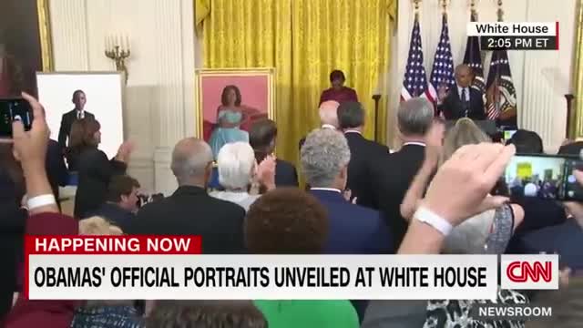 Barack Obama gives a speech after the unveiling of his White House portrait