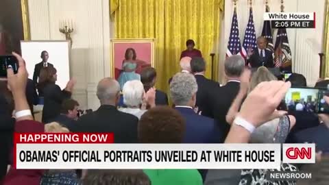Barack Obama gives a speech after the unveiling of his White House portrait