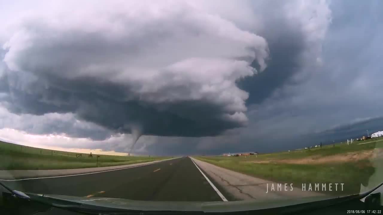 Storm chasing dashcam: Tornado crossing the highway! Laramie, Wyoming