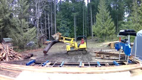 Loading log onto portable sawmill