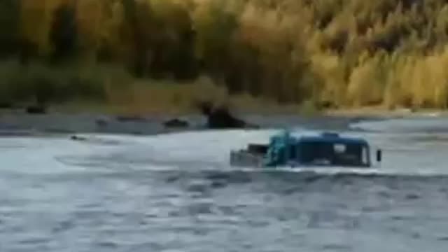 The truck travels along the bottom of the river.