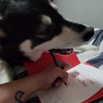 Molson signing his Christmas card