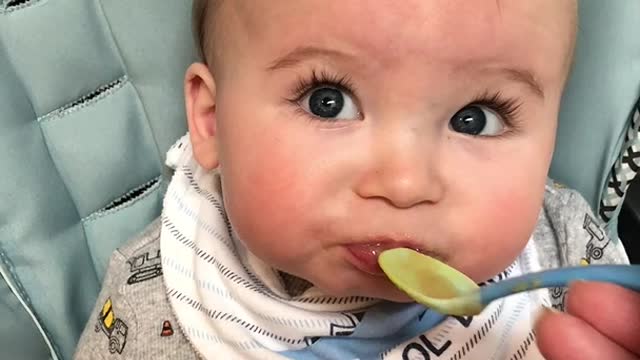 Little Baby Makes Funny Faces as He Tries New Food