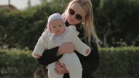 Mother and baby swaying in the park