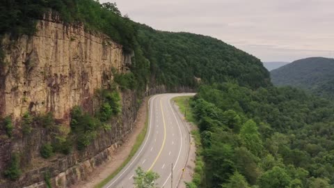 The bird view of a beautiful road that situvated in hill side