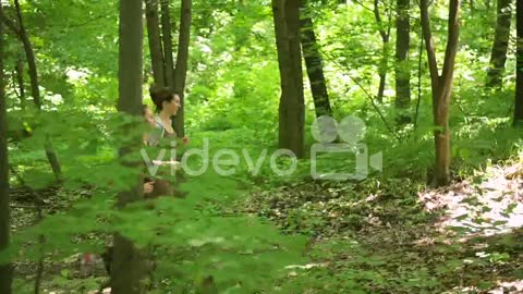 Two Happy Sportswomen Running In The Woods