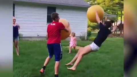 two brothers fight with giant rubber balls