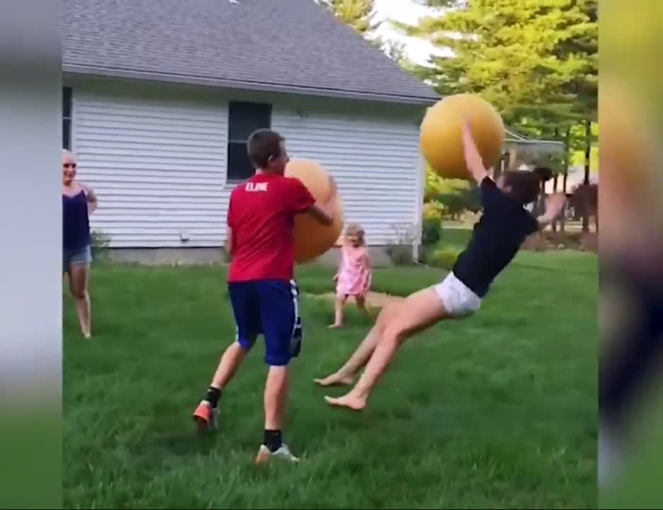 two brothers fight with giant rubber balls