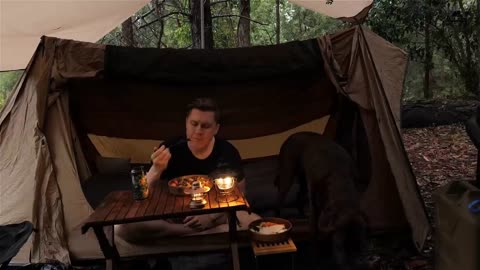 Eating barbecue in a tent on a rainy day