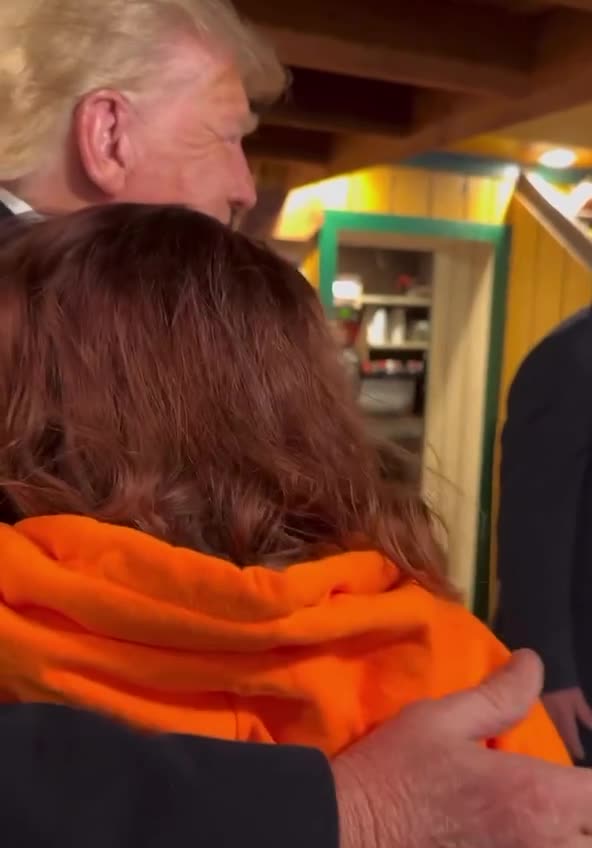 Trump gets a hug at the local BBQ joint called Machine Shed in Davenport, Iowa. March 13, 2023