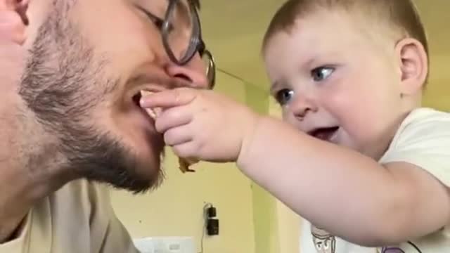 Enjoy this evil baby sharing his quesadilla