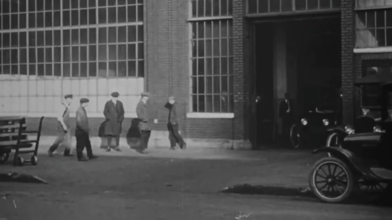 Cars are manufactured on an assembly line in 1918 at the Ford Motor Company short video no