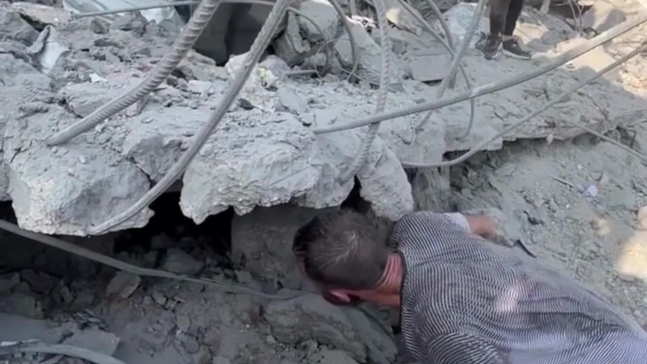 Palestinian man looks for family trapped under rubble in Gaza