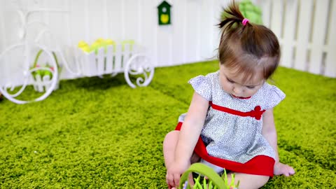 Little baby girl playing in the garden