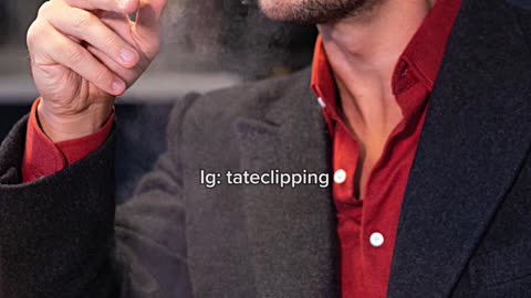 Tristan Tate smoking a CIGAR while waiting for food