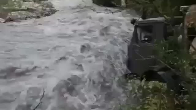 Scale of a truck driver crossing a stream