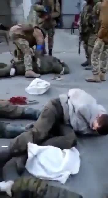 Additional angle of Ukrainian soldiers torturing Russian prisoners.