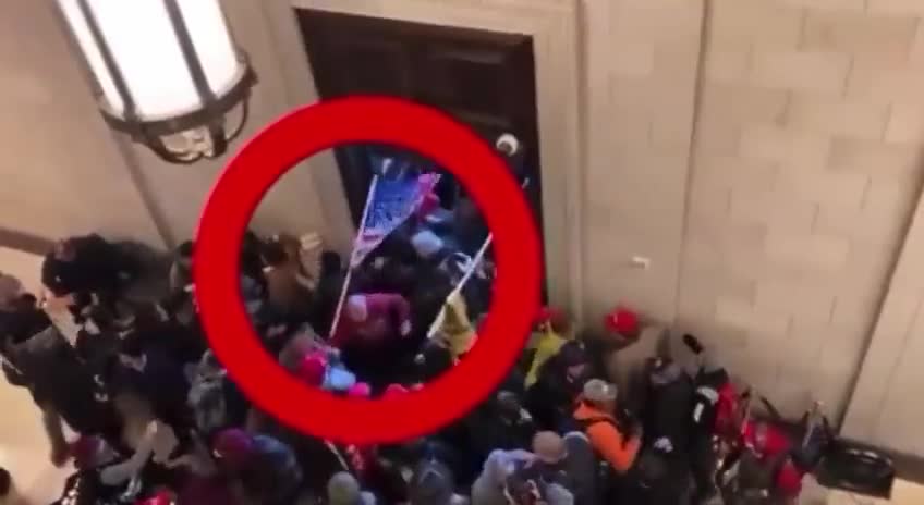 Guy wearing an earpiece physically forcing people inside the Capitol J6