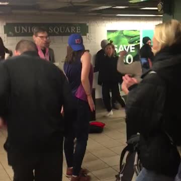 Several people have dance party in subway station