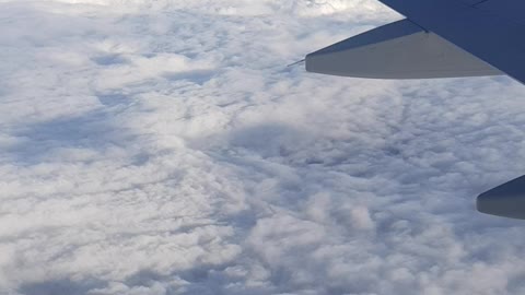 Watching the clouds from an airplane
