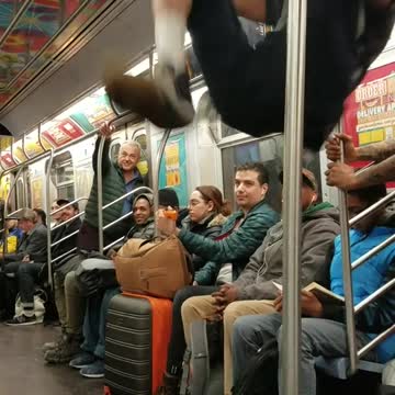 Subway dancers do hat flip tricks and spin around on poles