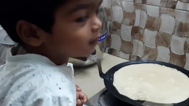 Cute boy in the kitchen and making breakfast