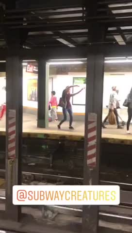 Blonde woman striped shirt dance on subway platform
