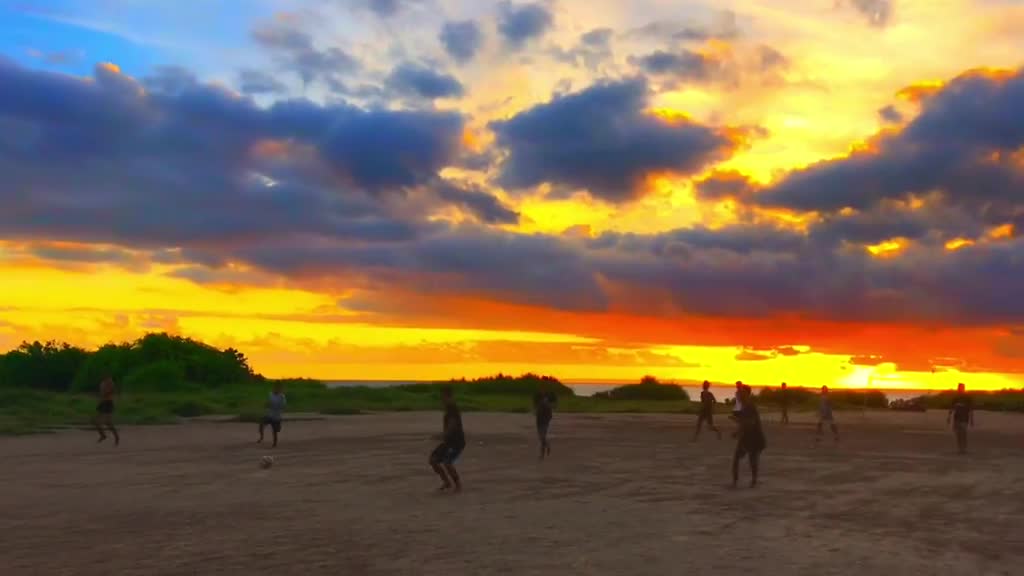 Children playing football under the sunset glow 1