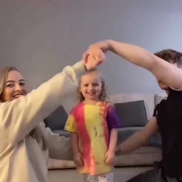 Mom and Dad playing with their cute little daughter