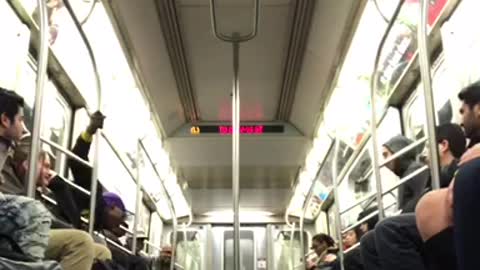 Man in purple hat performs on subway